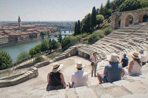 Small group listening to a guide in a Verona piazza