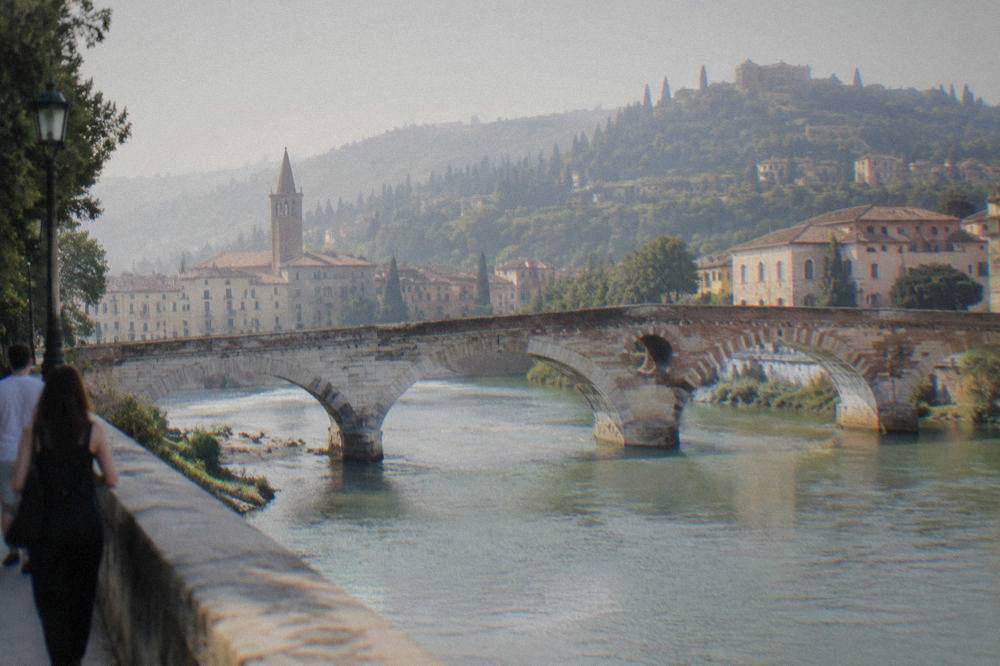 The Adige river curving around Verona's old centre with Ponte Pietra and the hillside above
