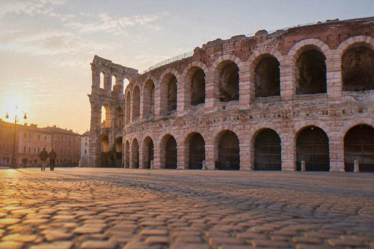 The Roman Arena of Verona seen from Piazza Bra in warm evening light