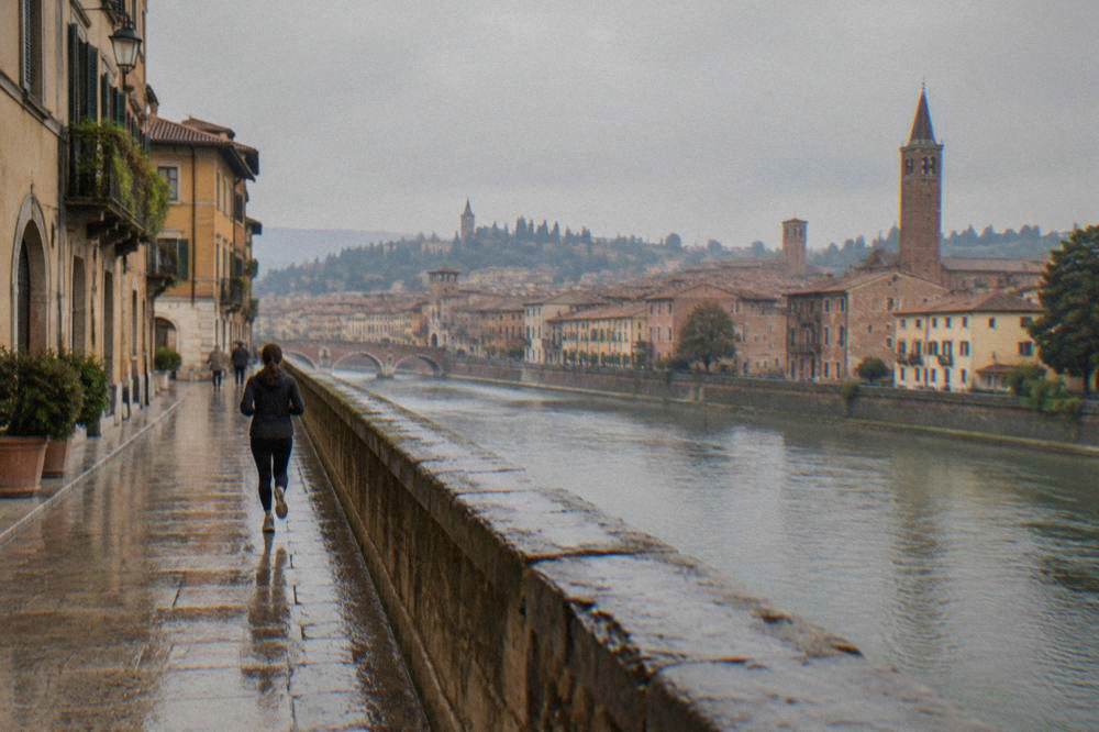 The Adige river in Verona seen from a bridge with the old town rooftops beyond