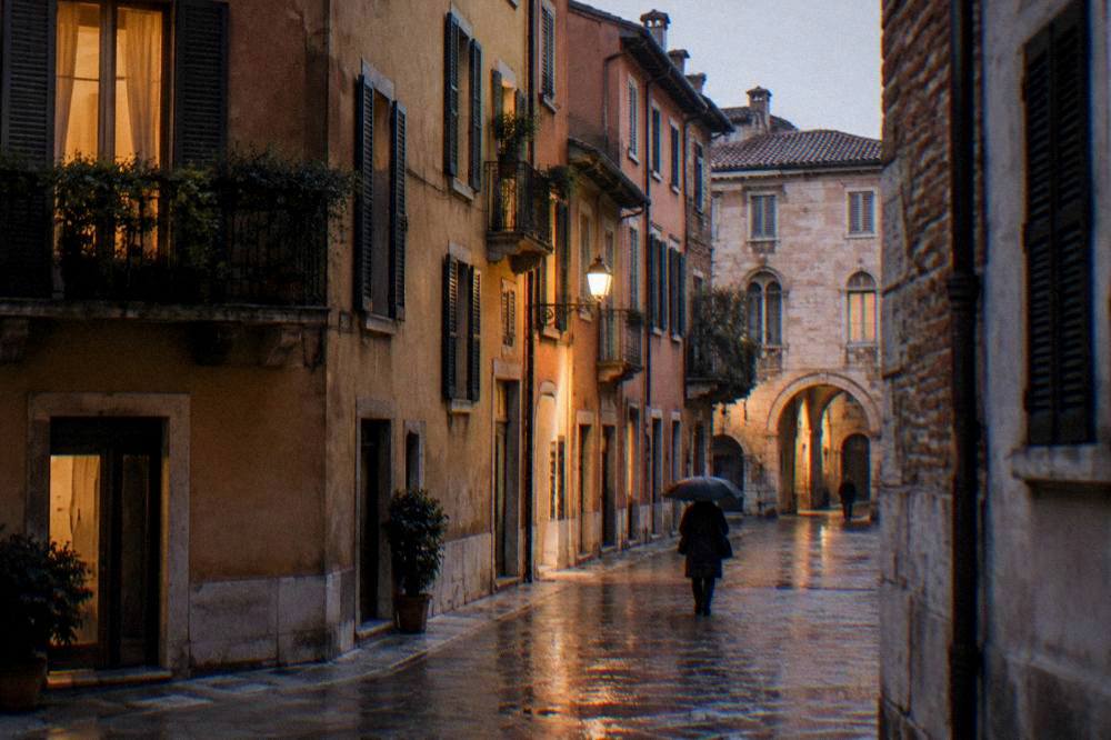 Evening light on a quiet residential street in northern Verona with warm windows