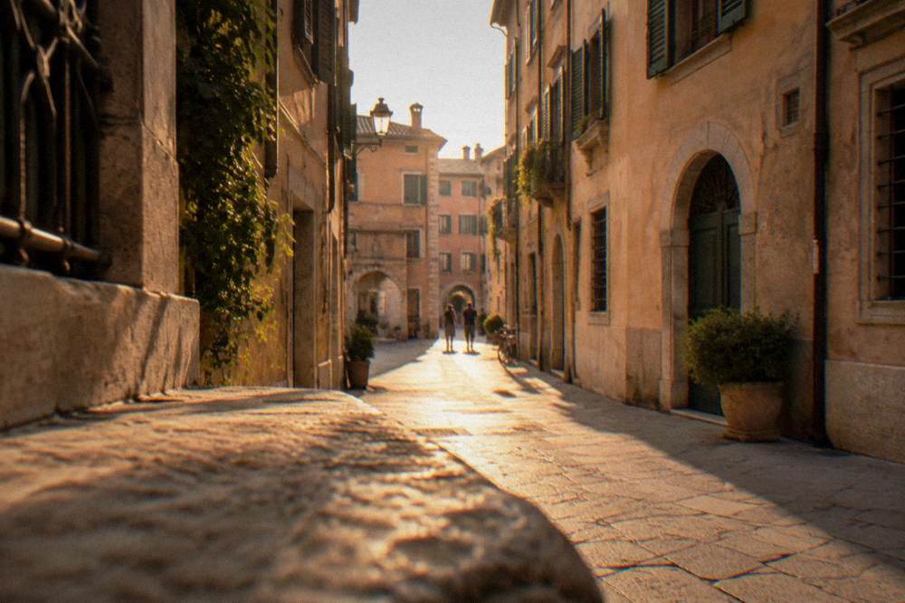 Narrow historic lane in the old town with pale stone and shuttered windows