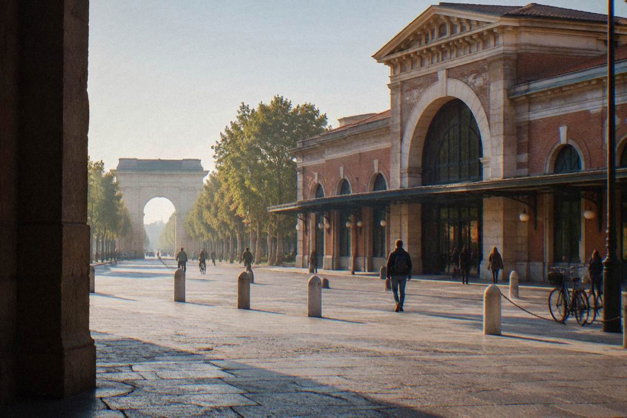 The brick facade and arched entrance of Verona Porta Nuova railway station seen from the square outside