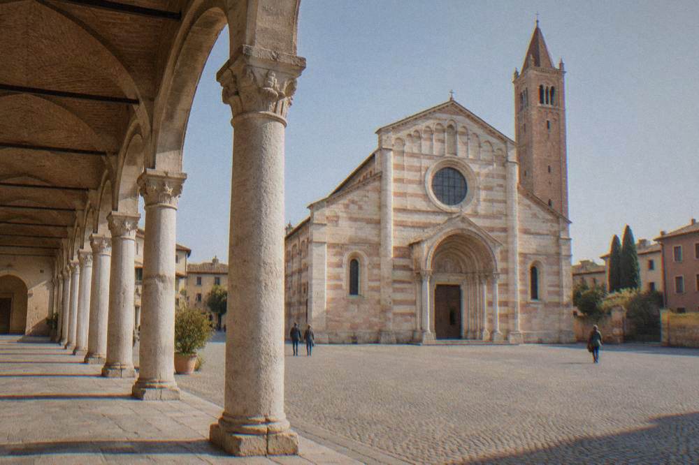 A covered arcade with stone columns beside the Basilica di San Zeno in Verona