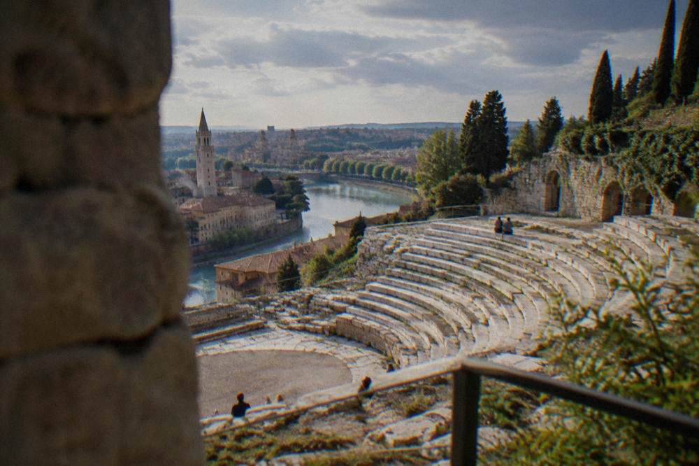 The Roman cavea of the Teatro Romano in Veronetta, Verona, with stone seating tiers facing the river