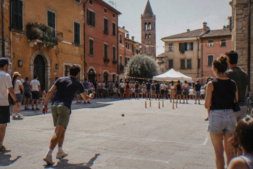 Crowds watching a street game during a festival in a Veronetta square in Verona