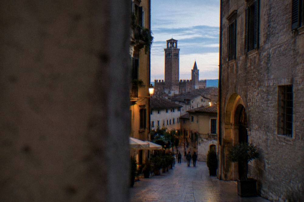 Evening light on medieval brick towers and rooftops in central Verona