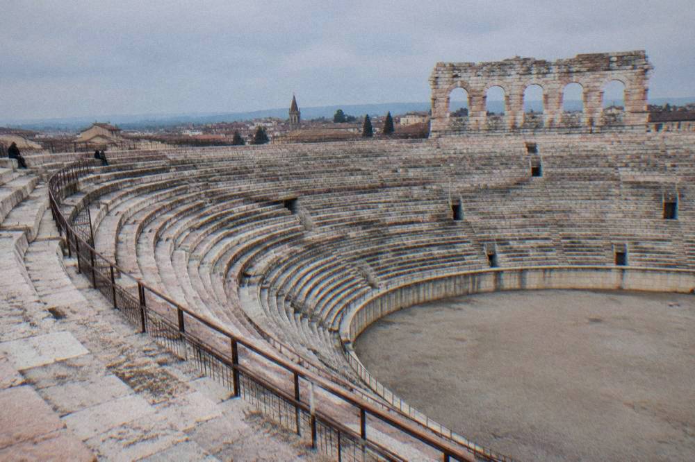 The curved stone seating tiers of the empty Arena seen from the upper gallery