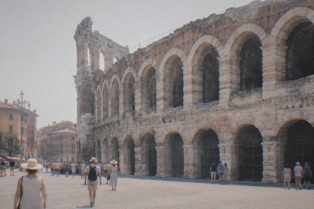 A Roman amphitheatre seen from a paved square at the edge of Verona's old centre