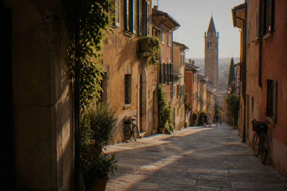 Narrow lane climbing the Veronetta hillside toward the castle grounds