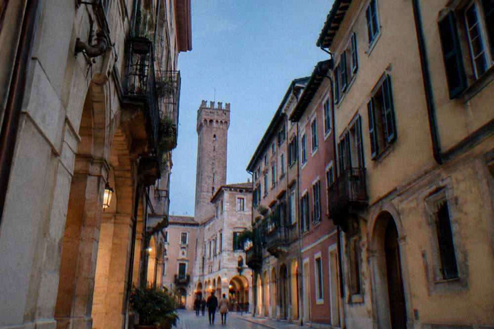 Visitor reading a map on a Verona square before climbing to the viewpoint