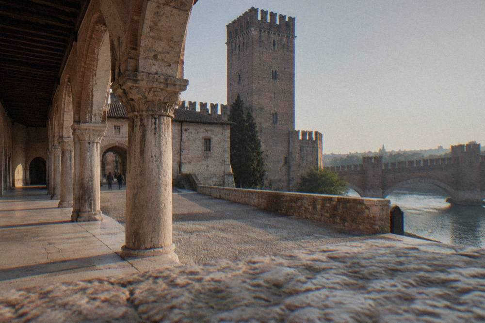 Courtyard inside Castelvecchio with stone walls and an arched walkway