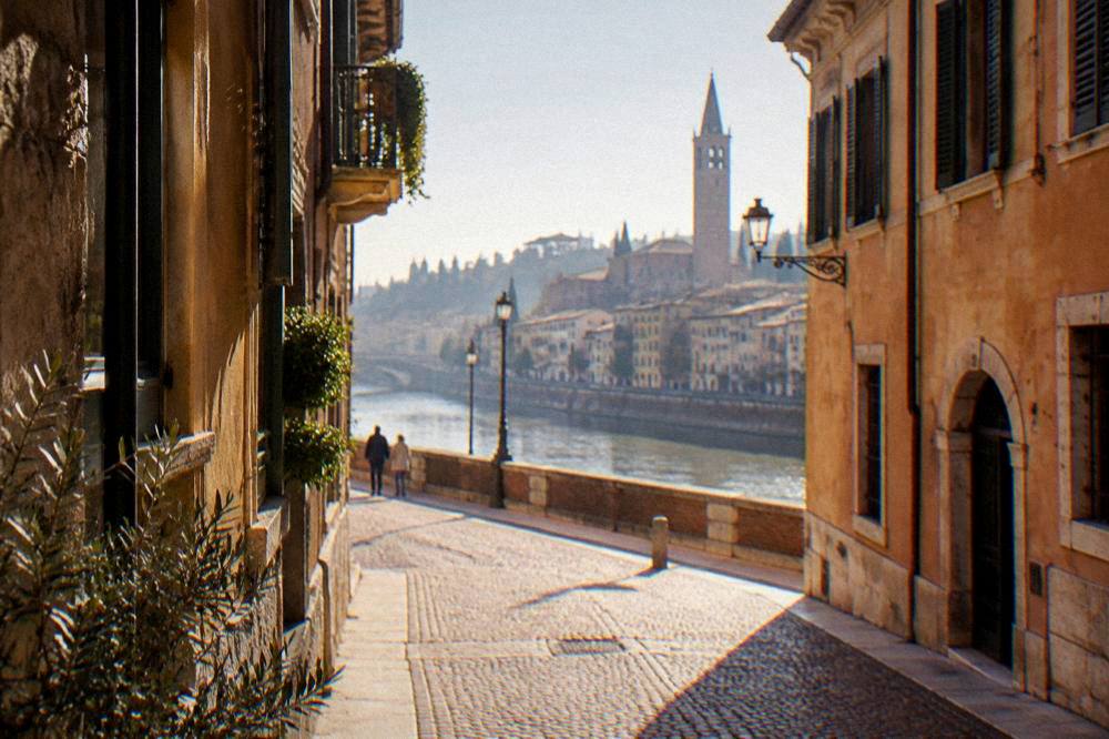 Narrow cobbled street of old Verona with ochre buildings near the river