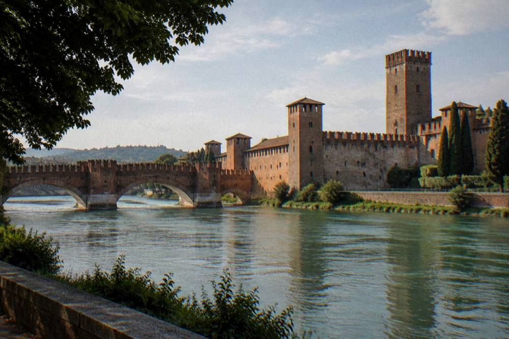 Wide view of the fortress walls, bridge and river from the opposite bank