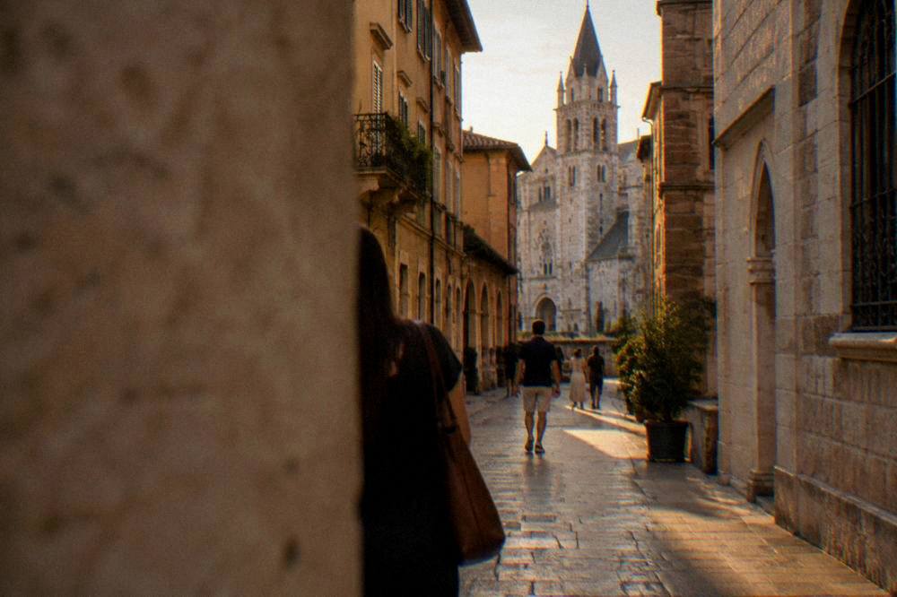 A walking street near Verona Cathedral at dusk with warm light on stone buildings