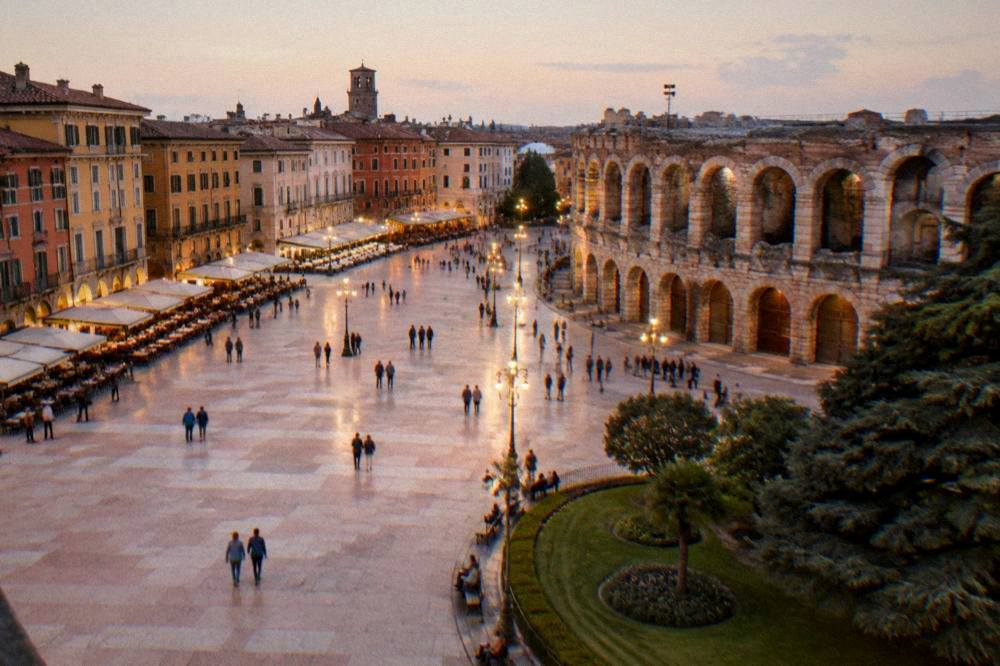 Evening light on Piazza Bra with the museum arcade and lamplight along the promenade