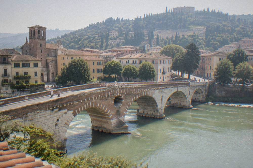 A steep hillside above a river with a Roman theatre and a panoramic terrace at the top