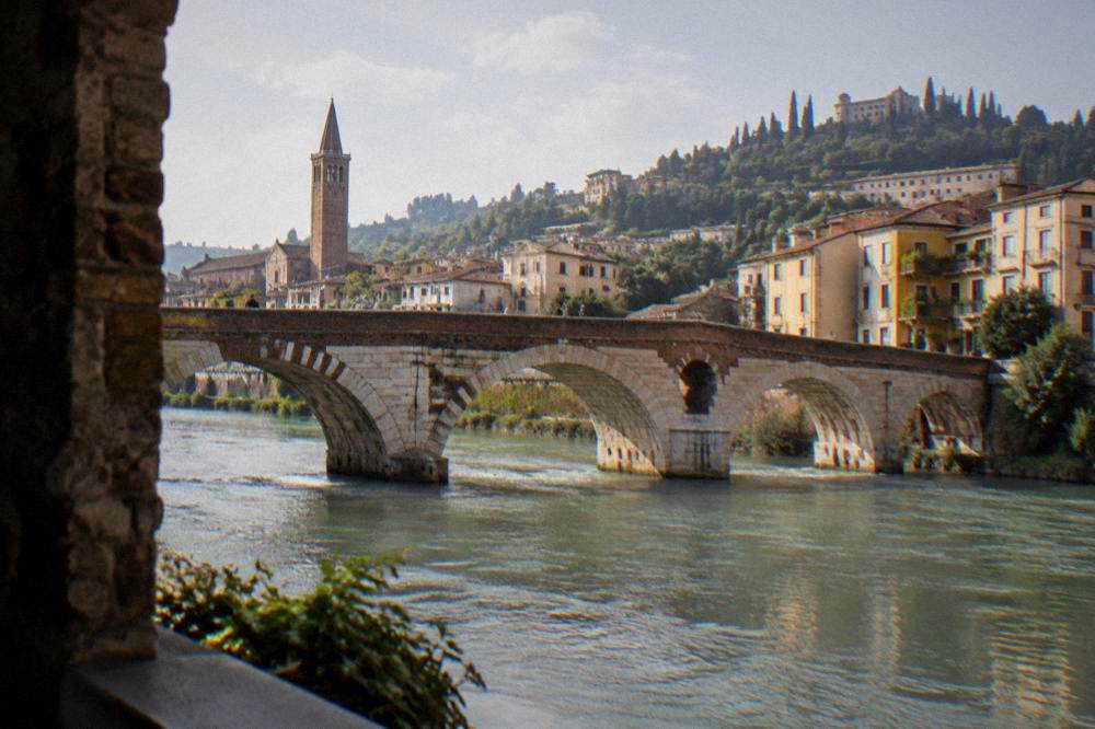 Arched stone and brick bridge over a green river