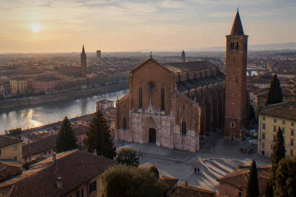 Wide view across rooftops and church towers at golden hour