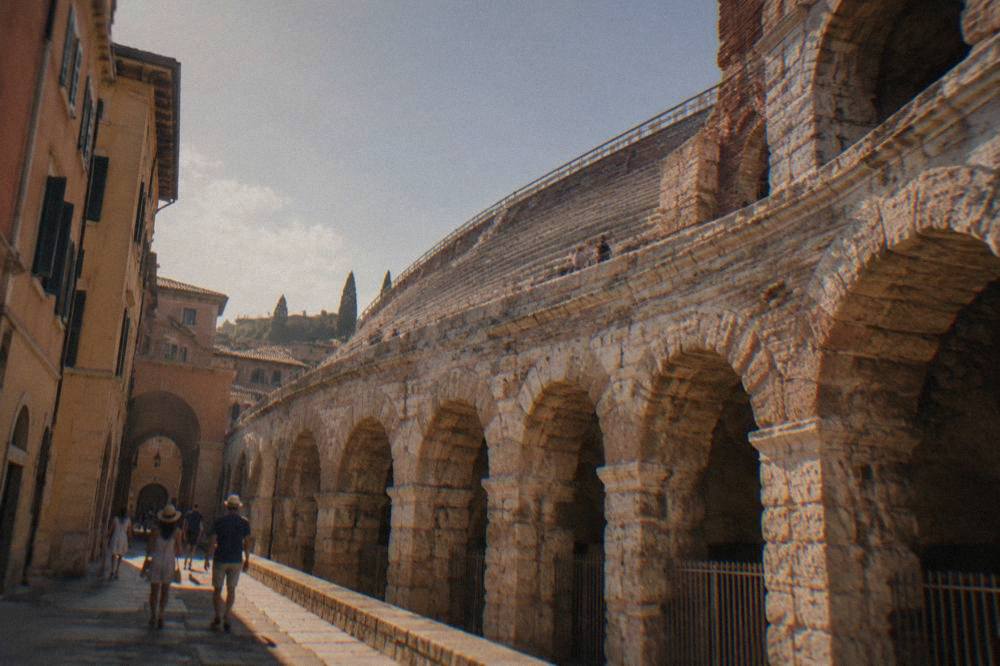 Stone arches and stepped seating of the ancient theatre seen from the lower walkway in Verona