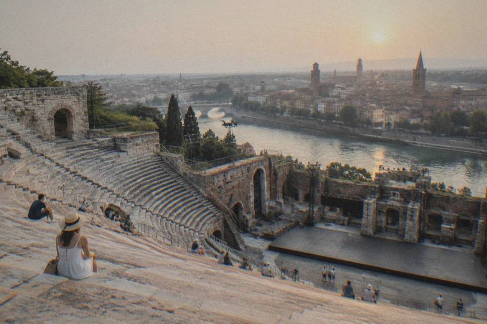 Evening light on the ancient stage area of the Roman theatre in Verona with the city beyond the river