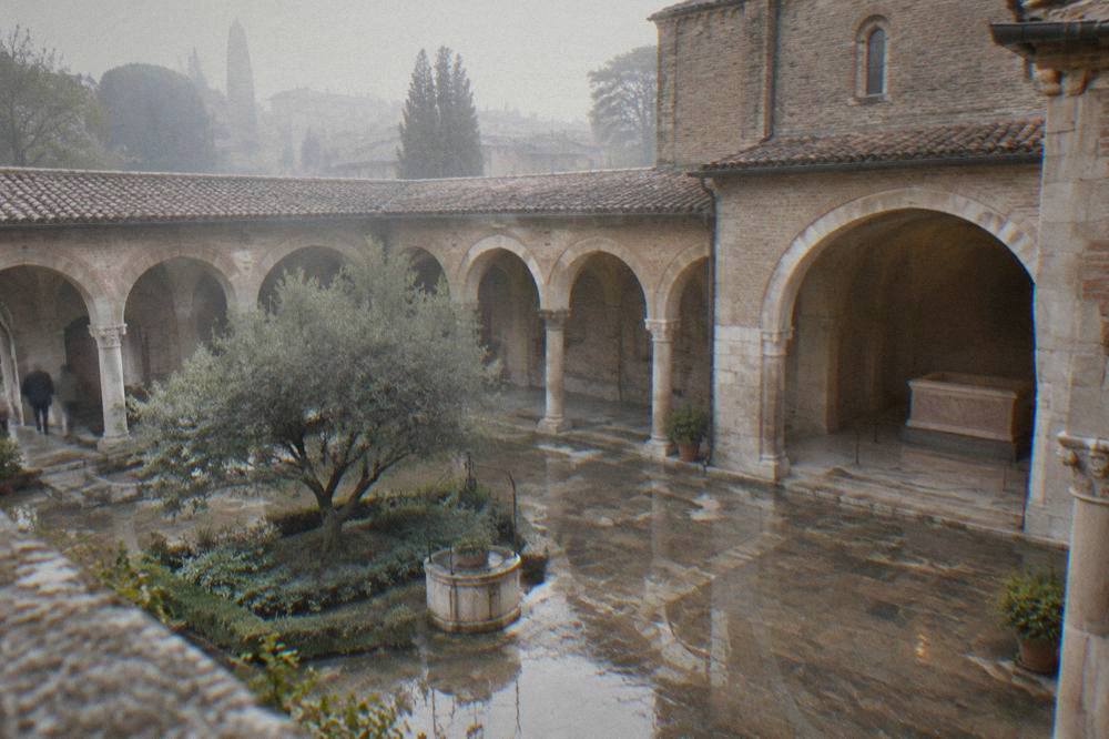 A rain-washed empty courtyard with old stone arcades reflecting in puddles