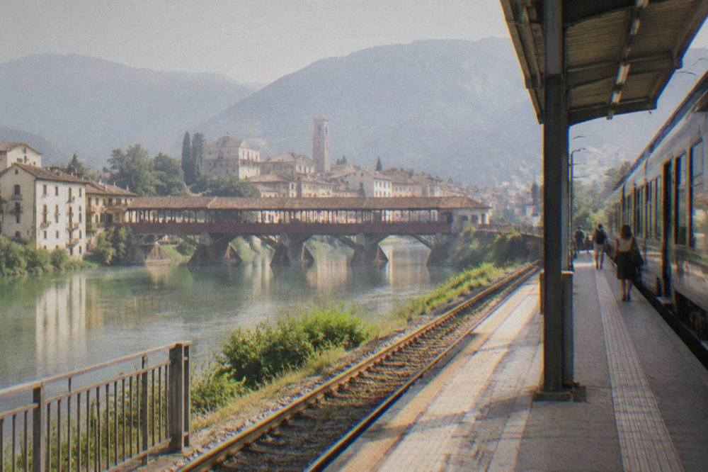 A regional train waiting at a platform outside an Italian railway station
