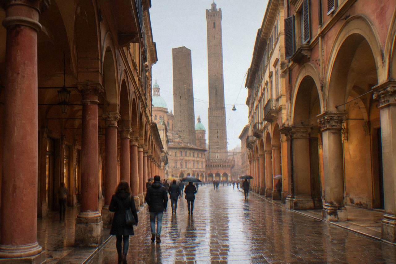 A long porticoed street in Bologna with arches on both sides and people walking in late afternoon light