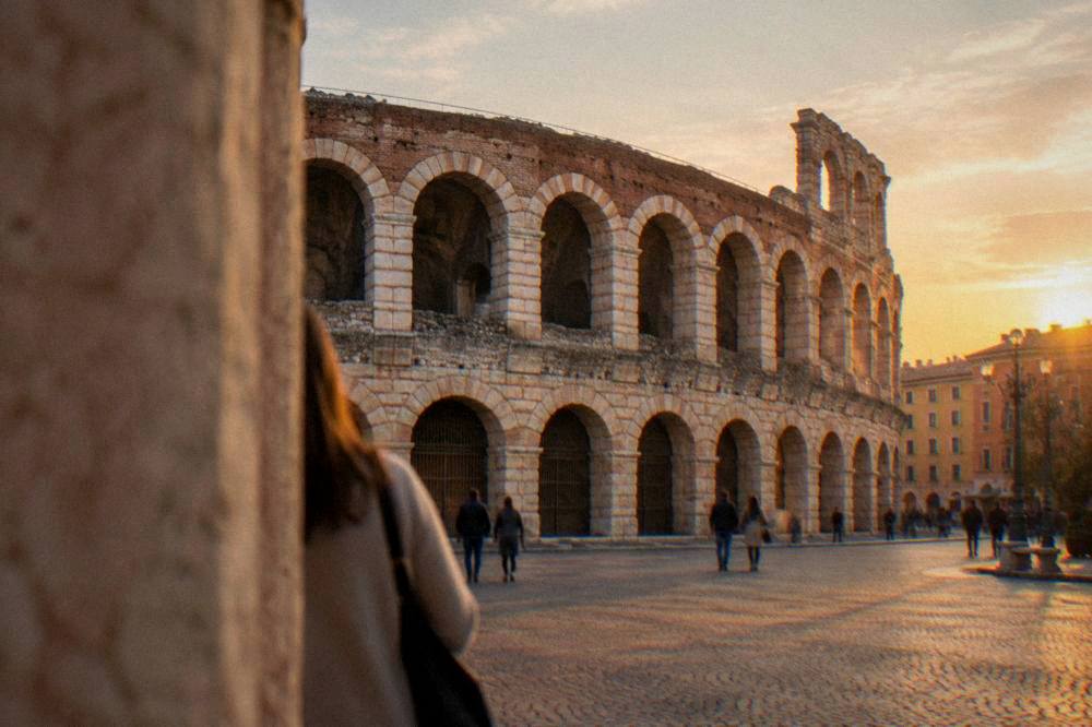 The Roman Arena in Verona seen from a piazza at golden hour