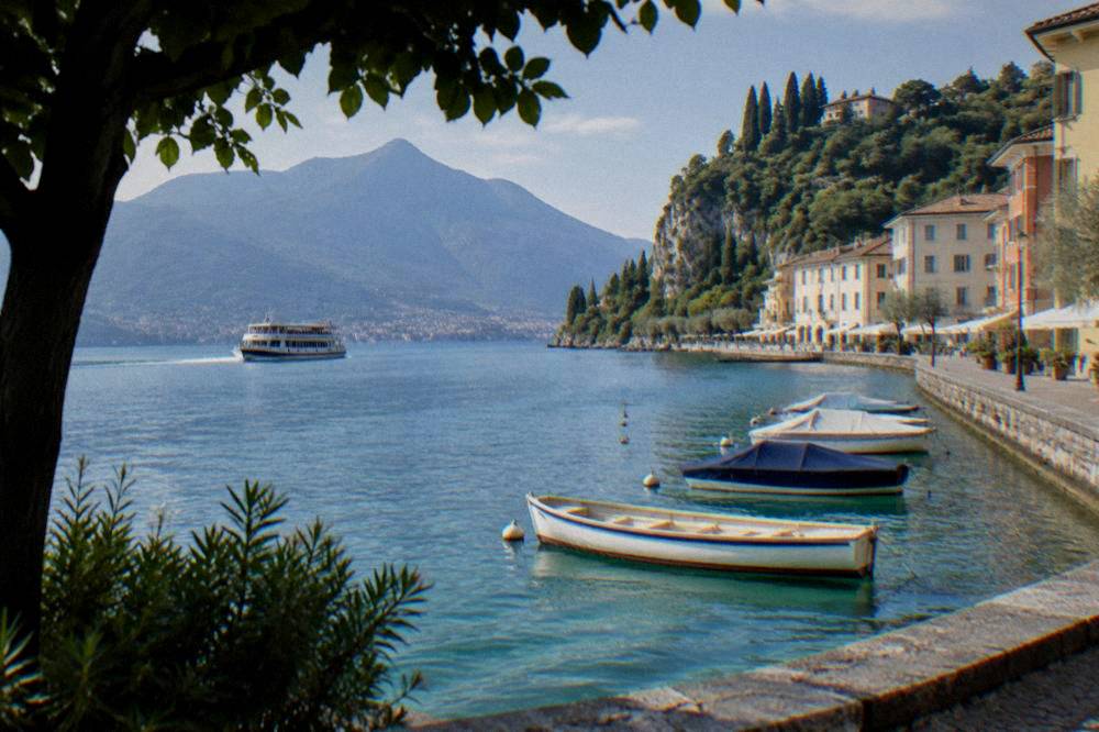 A passenger ferry crossing open water towards a lakeside town with hills behind