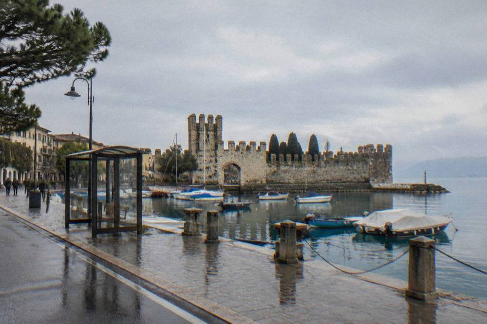 An ATC bus stop and lakeside street in Lazise with the shore road visible