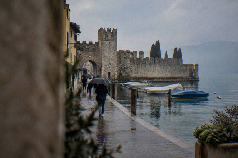 Visitors walking the lakeside promenade in Lazise in the morning