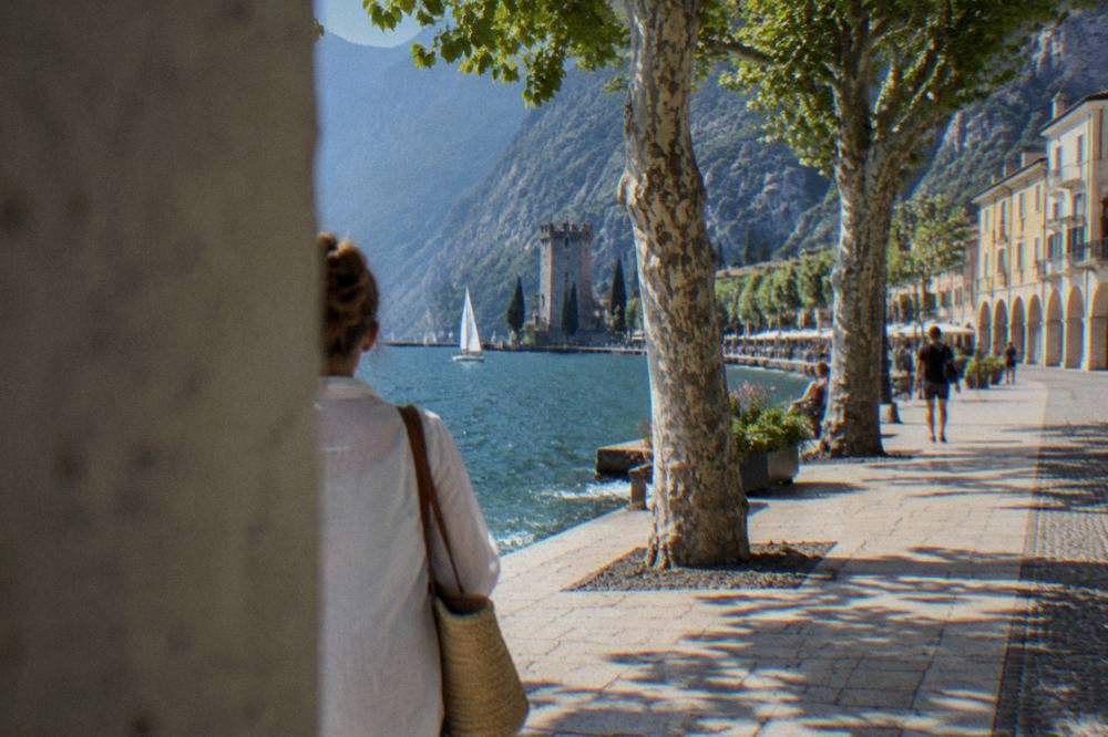 Old waterfront buildings with arcades along the quay at Riva del Garda