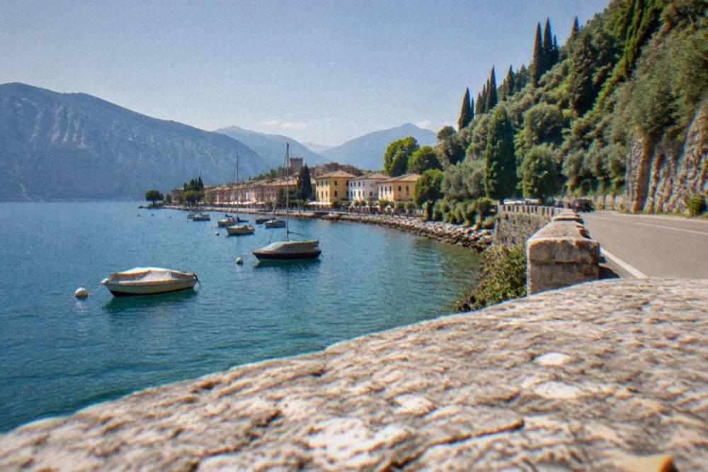 A mountain road curving along the wooded shore of the northern end of Lake Garda