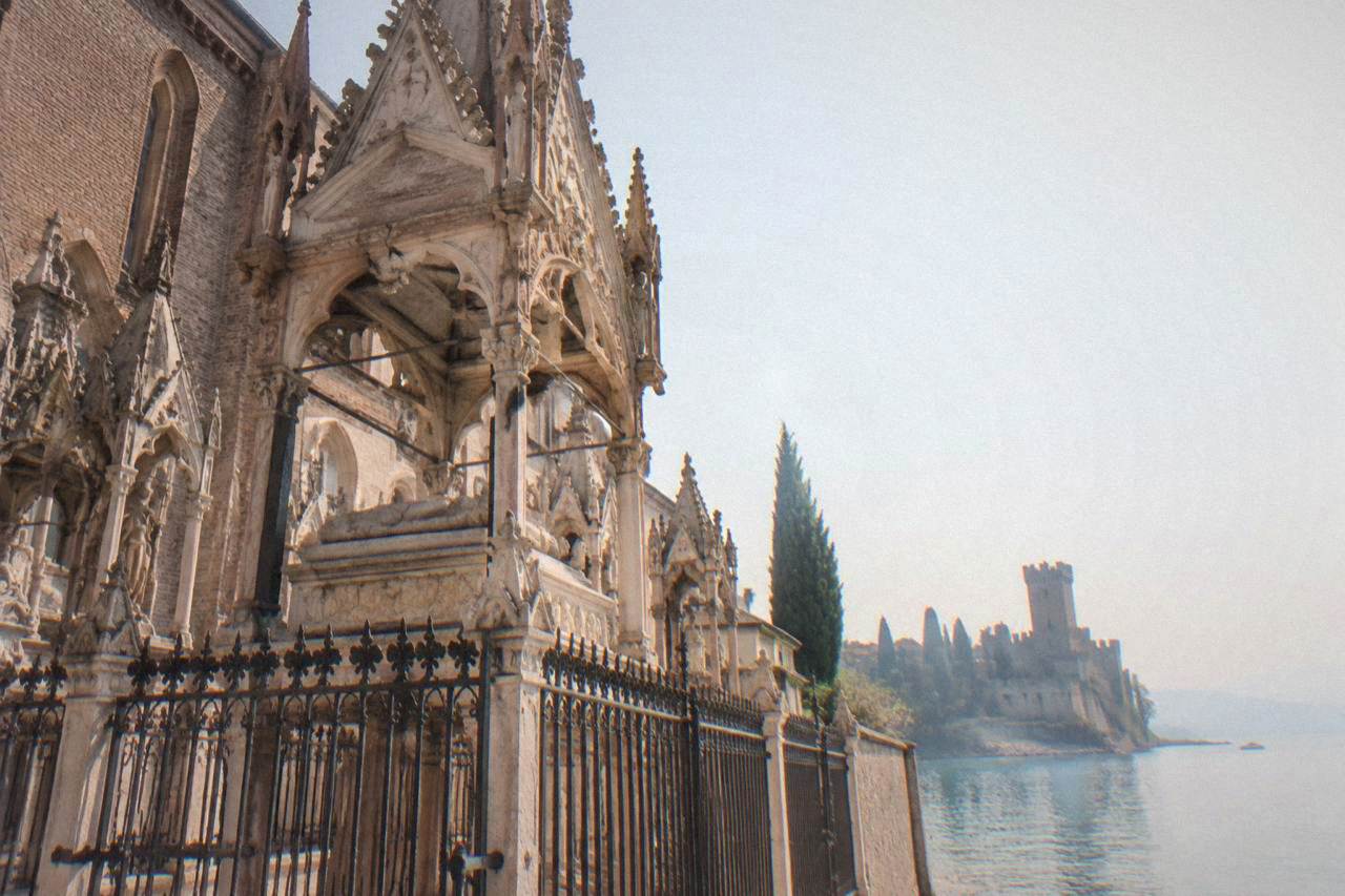 The narrow peninsula of Sirmione reaching into Lake Garda with the Scaliger Castle tower at its base