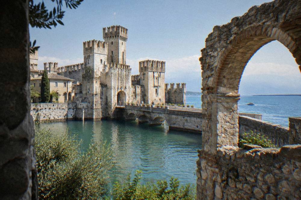 Stone arches of a Roman ruin overlooking Lake Garda at the tip of the Sirmione peninsula