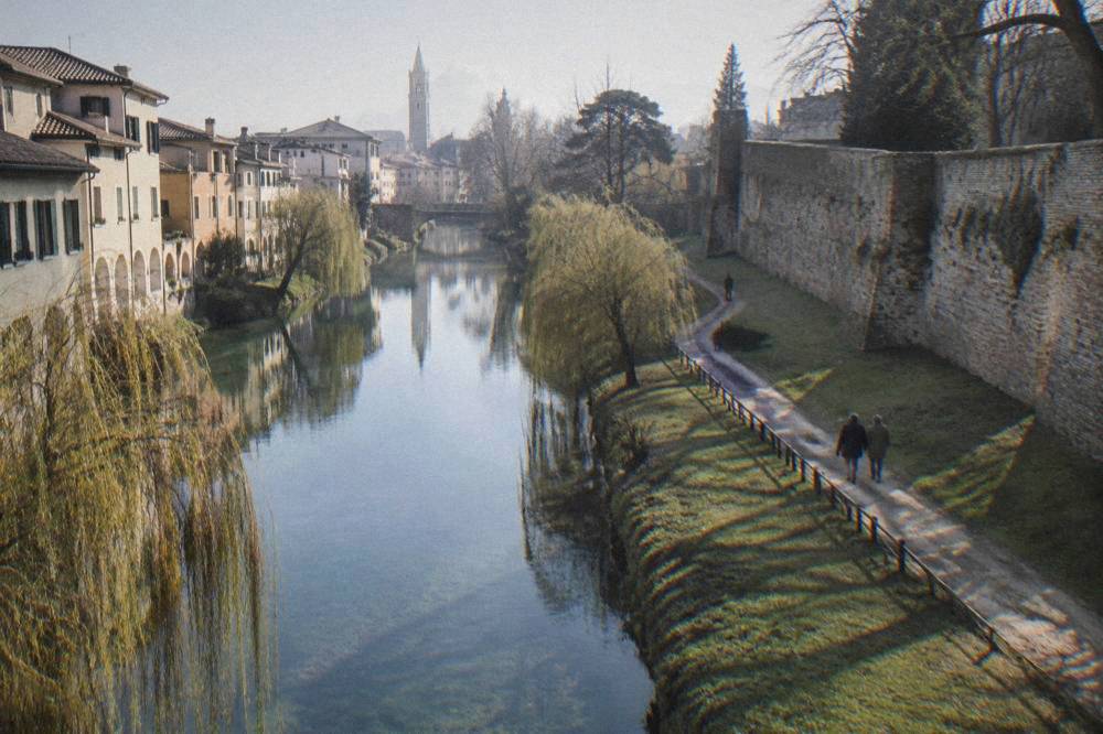 A stretch of Treviso's city wall with grassy banks and a path along it