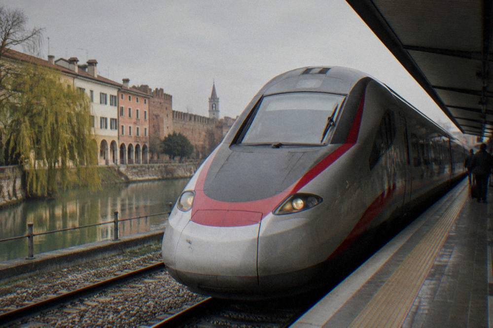 A fast train waiting at a platform in an Italian railway station