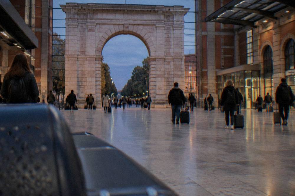 The Verona Porta Nuova railway station concourse with travellers and departure boards