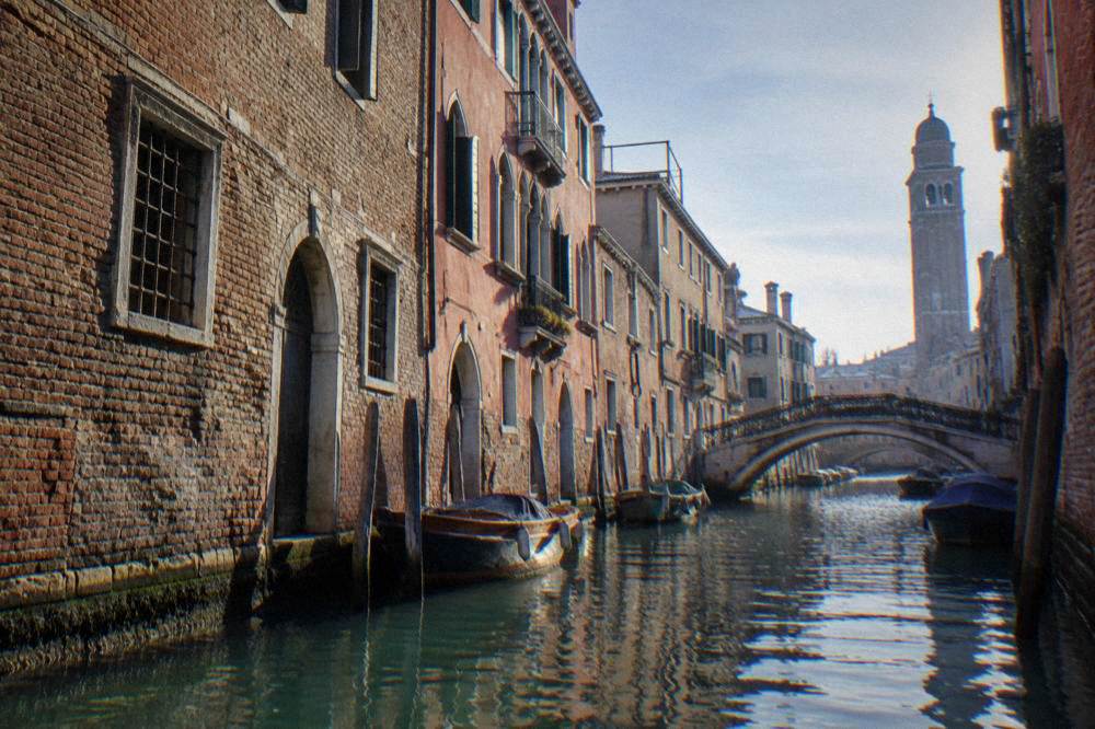 Canal lined with old brick buildings and a small bridge