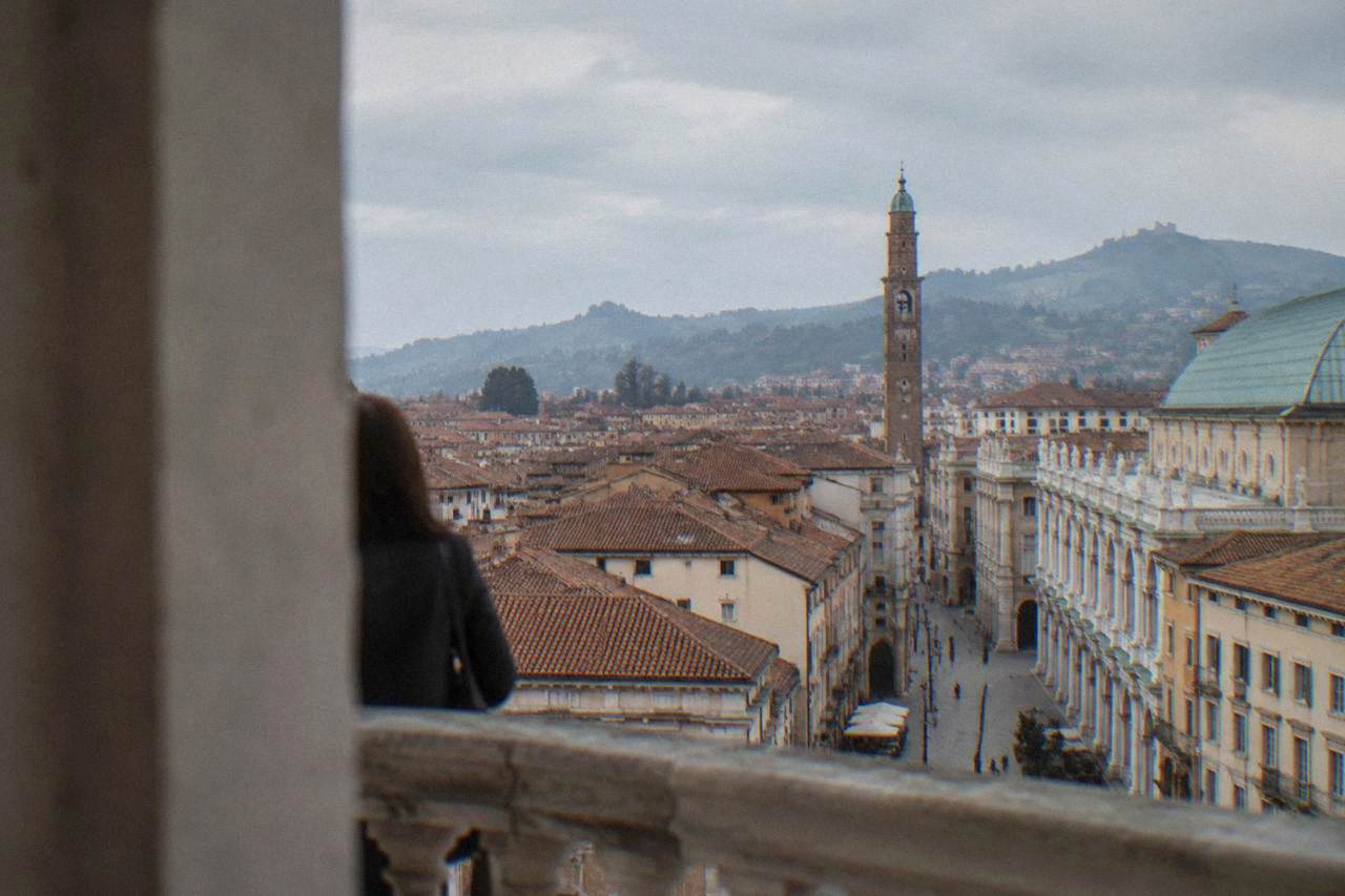 A quiet piazza in Vicenza with classical stone buildings under a soft afternoon sky