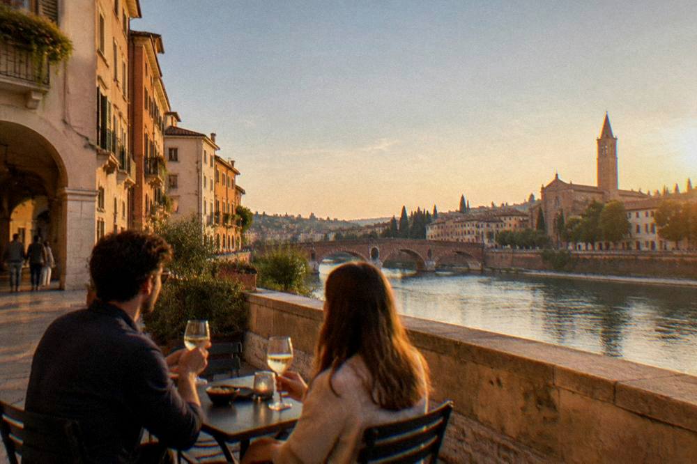 Two people sharing wine at an outdoor table on a Verona street in late afternoon
