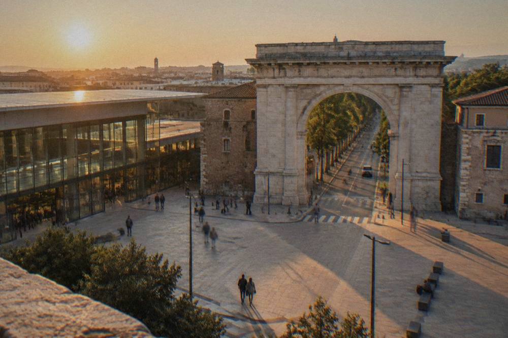 The modern glass front of Verona Porta Nuova railway station seen from the square outside