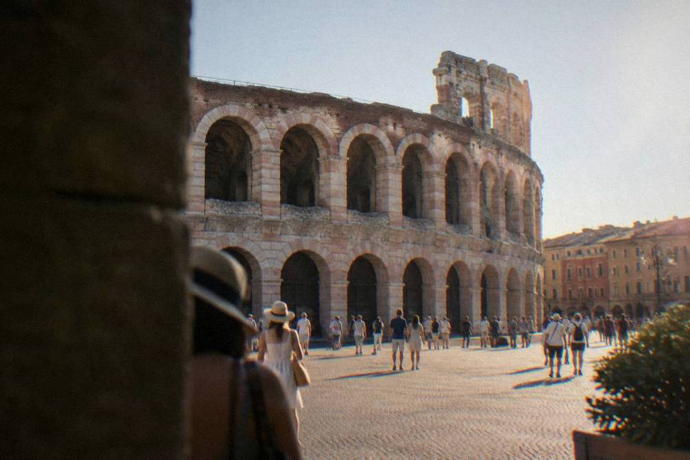 The pink marble Arena amphitheatre in Verona seen from Piazza Bra on a clear afternoon