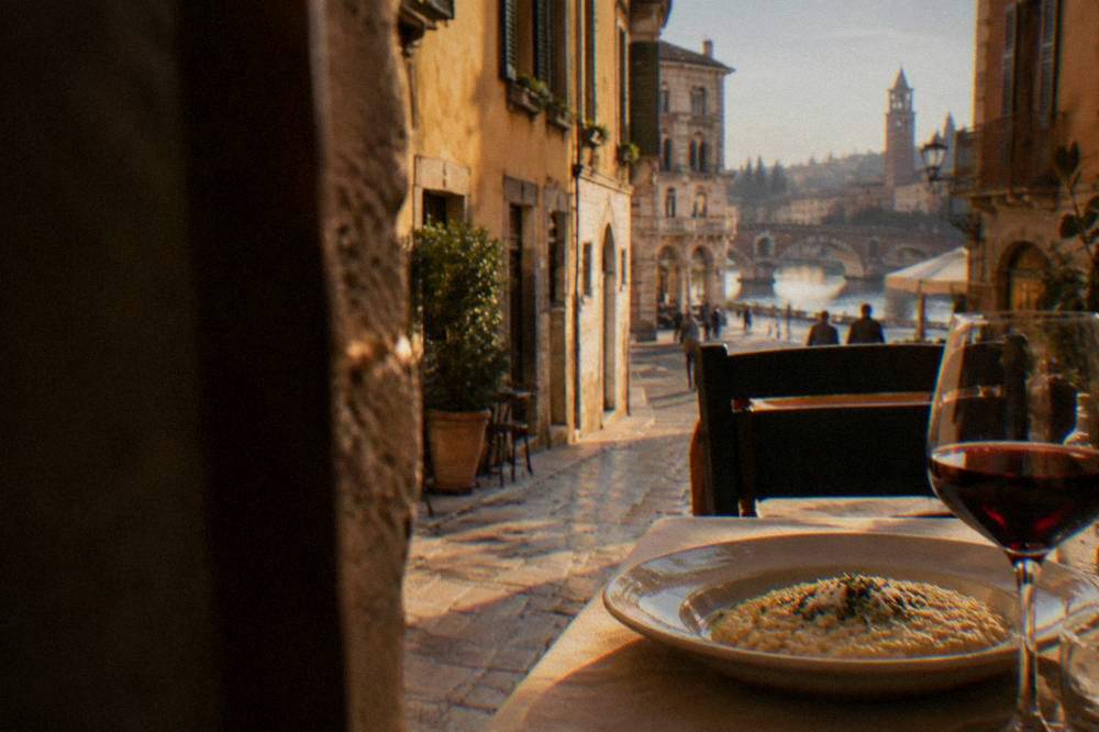 A table with a plate of risotto and a glass of red wine in a Verona restaurant