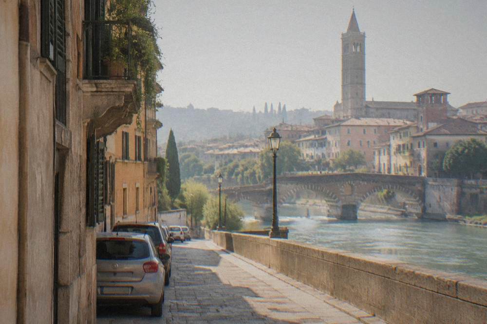 Cars parked outside the medieval walls of Verona near a restricted traffic zone gate