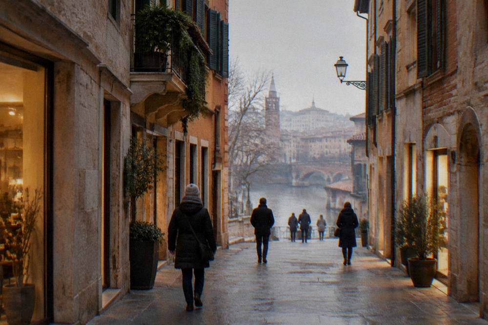 A narrow Verona street in winter with warm light from shop windows