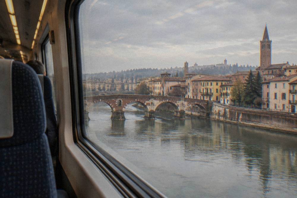 Modern high-speed train interior with rows of seats and large windows