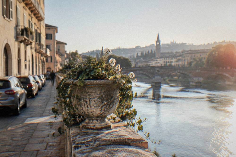 Cars parked outside the historic centre of Verona near the Adige river