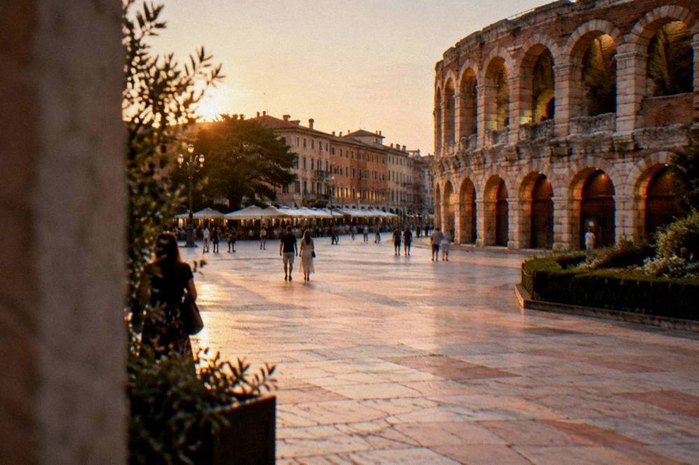 Verona's Piazza Bra at dusk with the Arena's arched facade lit warmly